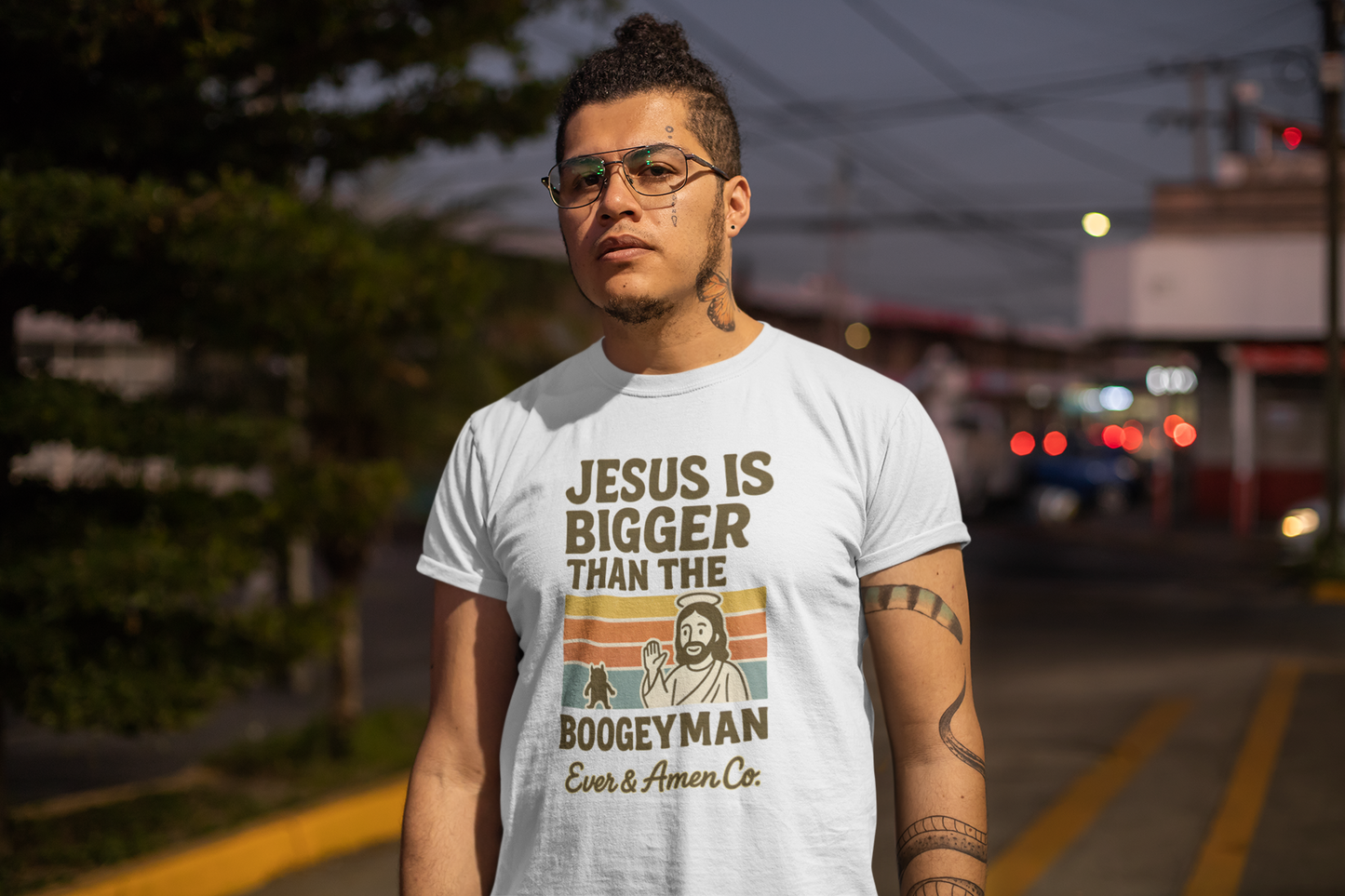 Men’s Christian graphic tee with bold text reading “Jesus Is Bigger Than the Boogeyman.” Modern faith-based shirt perfect for church, everyday wear, or outreach. Designed by Ever & Amen Co. to inspire courage and faith over fear.
