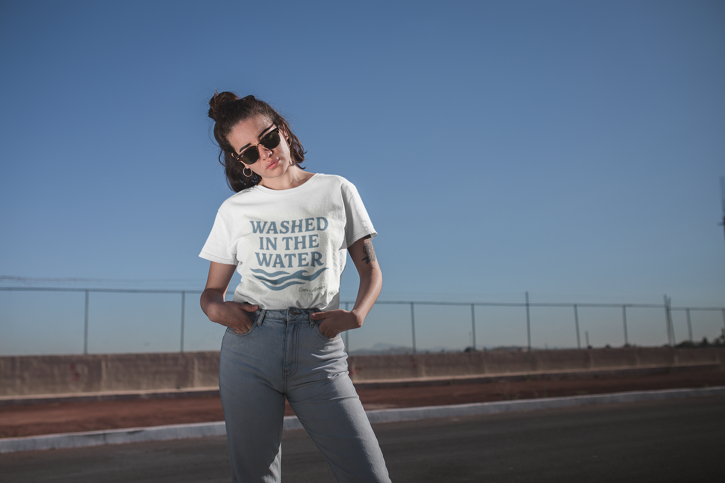 Unisex Christian tee with “Washed in the Water” design, symbolizing baptism and new life in Christ. Faith-based shirt by Ever & Amen Co.