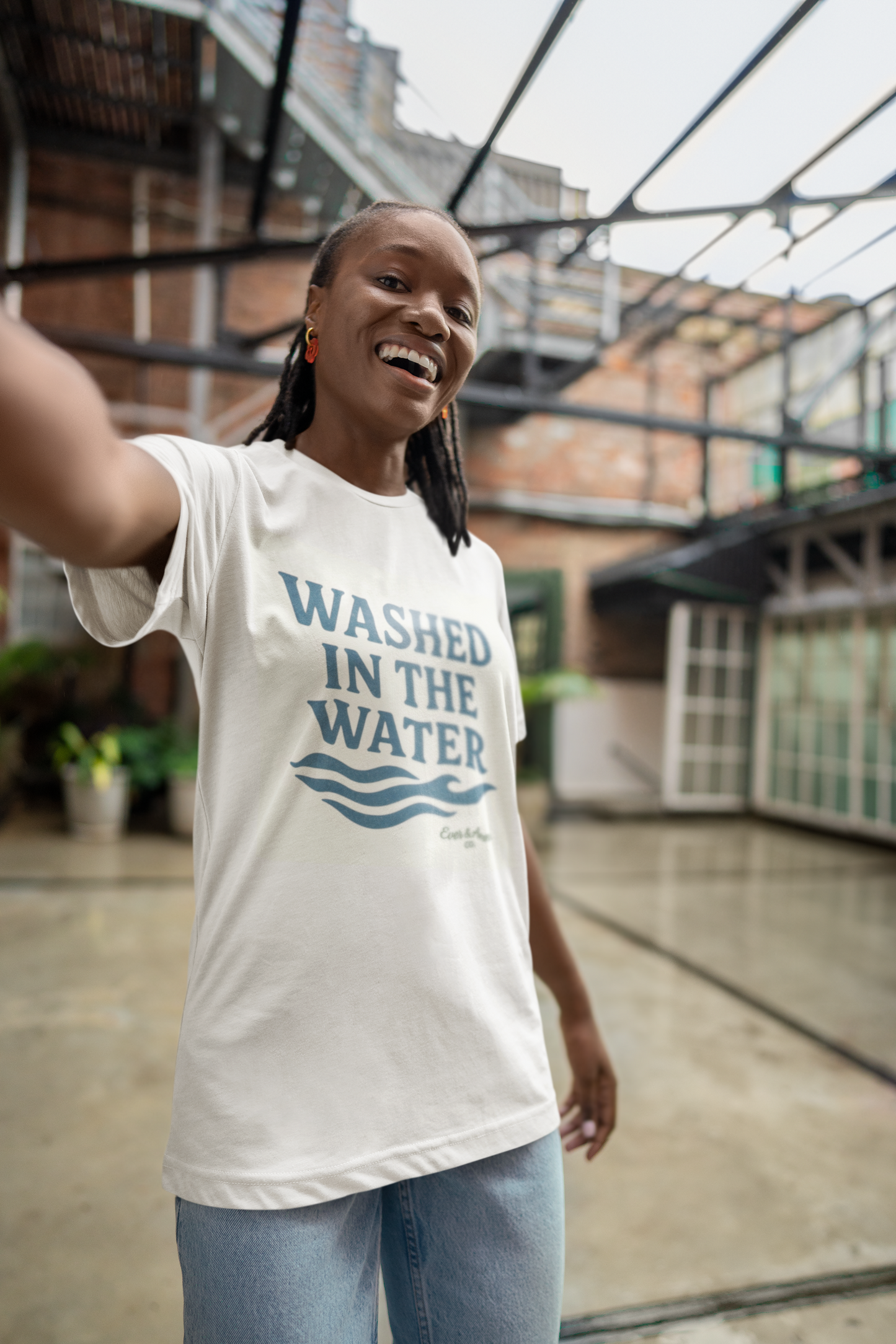 Unisex Christian tee with “Washed in the Water” design, symbolizing baptism and new life in Christ. Faith-based shirt by Ever & Amen Co.