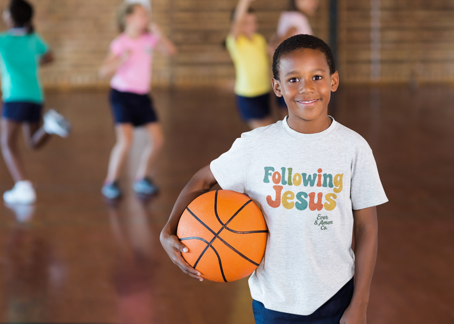 Christian t-shirt for kids with a simple “Following Jesus” print. Faith-based and play-ready.