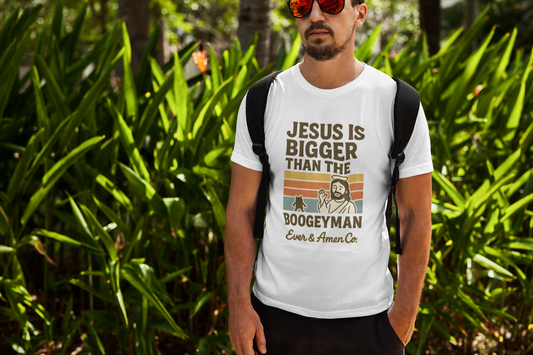 Men’s Christian graphic tee with bold text reading “Jesus Is Bigger Than the Boogeyman.” Modern faith-based shirt perfect for church, everyday wear, or outreach. Designed by Ever & Amen Co. to inspire courage and faith over fear.