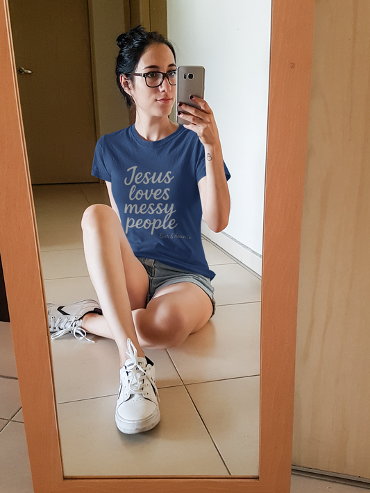 Women’s Christian graphic tee with the phrase “Jesus Loves Messy People.” Soft and stylish faith-based shirt celebrating God’s grace and unconditional love. Perfect for church, Bible study, or everyday wear. Designed by Ever & Amen Co.