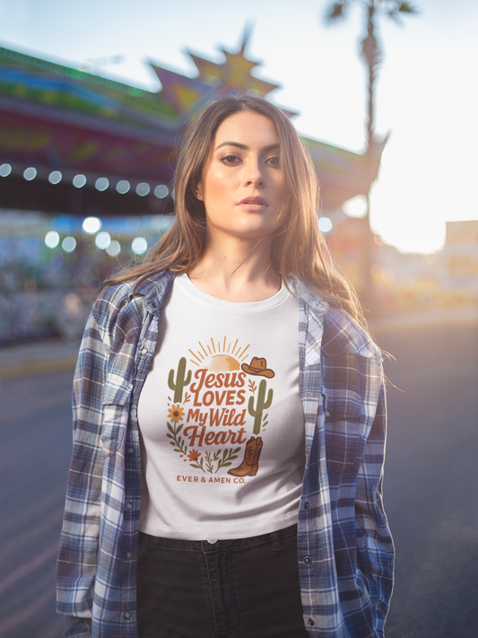 Ladies’ Christian graphic tee with the phrase “Jesus Loves My Wild Heart.” Soft, stylish, and faith-inspired shirt perfect for church, Bible study, or casual wear. Designed by Ever & Amen Co. to celebrate God’s love and individuality.