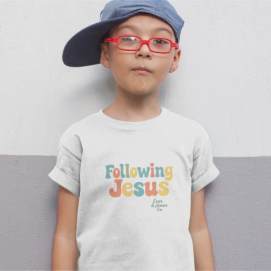Faith-inspired children’s tee with “Following Jesus” graphic. Soft, unisex Christian apparel for kids.