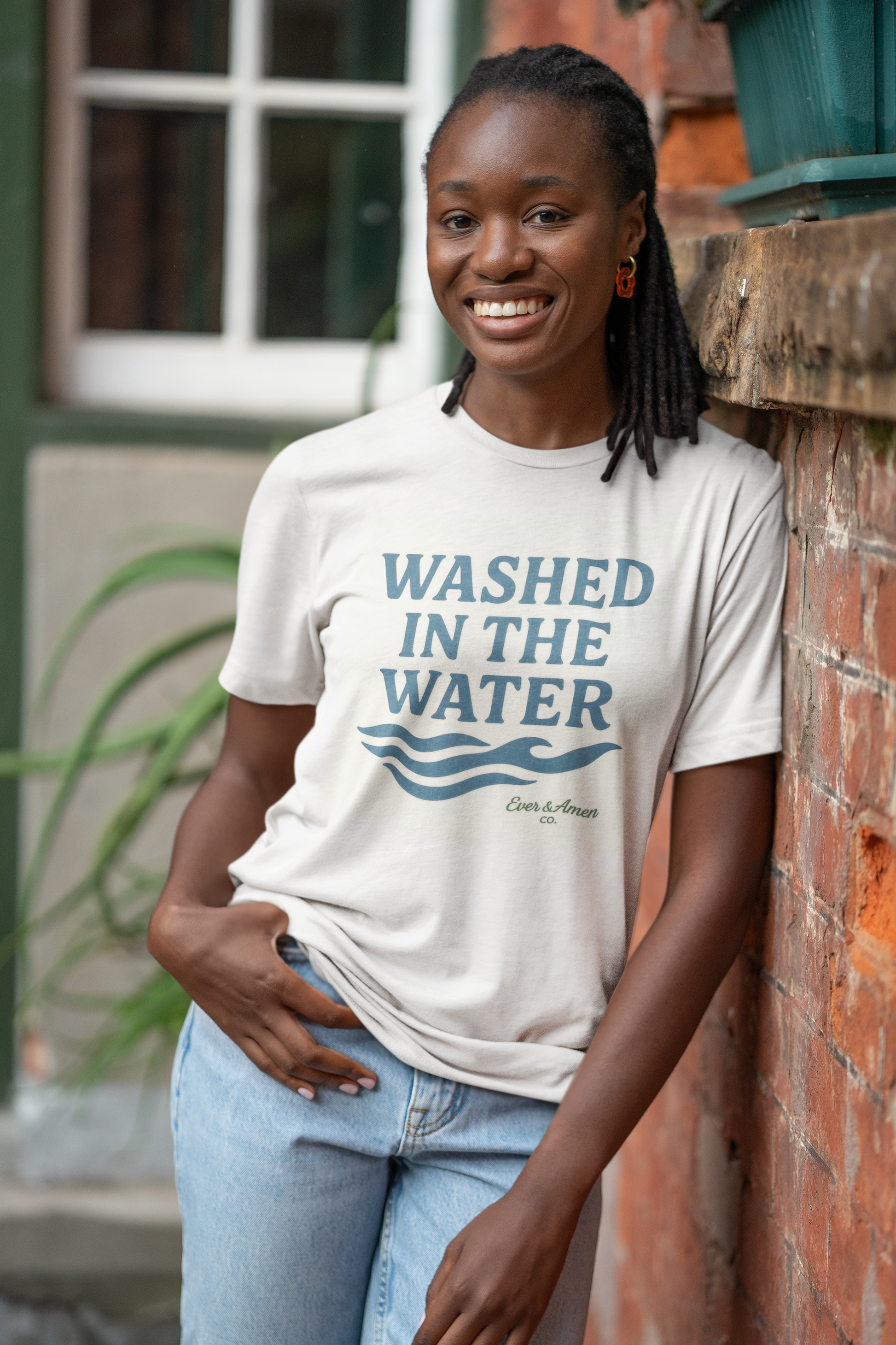 Unisex Christian tee with “Washed in the Water” design, symbolizing baptism and new life in Christ. Faith-based shirt by Ever & Amen Co.